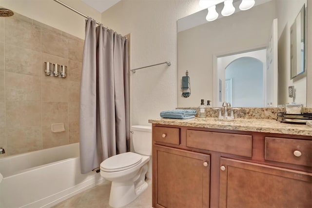 full bathroom featuring tile patterned floors, shower / bath combination with curtain, toilet, and vanity