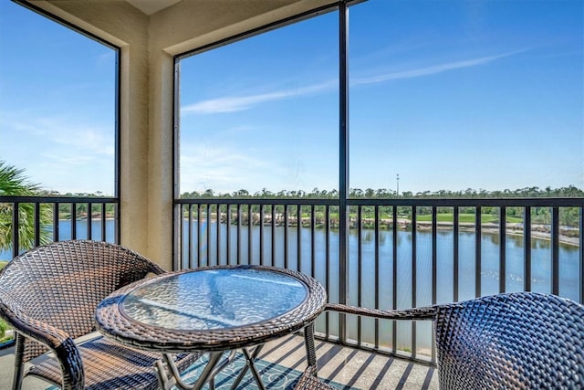 sunroom / solarium with a water view