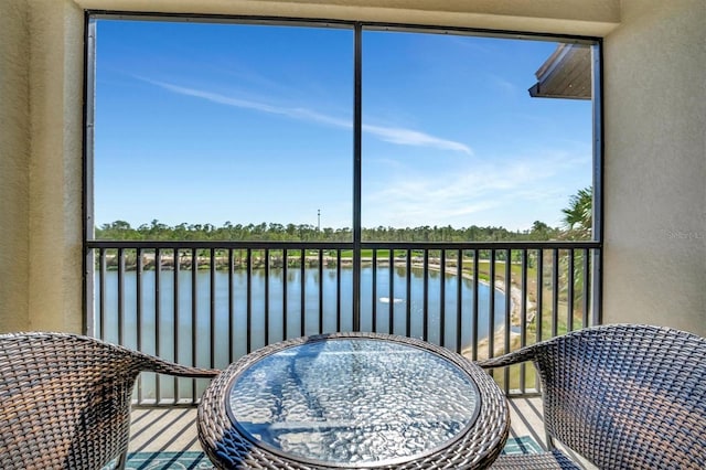 sunroom / solarium with a water view