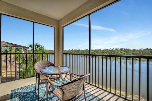 sunroom / solarium with a water view