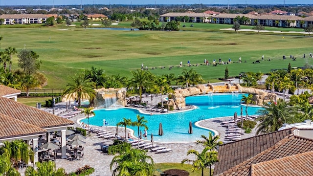 view of swimming pool with pool water feature