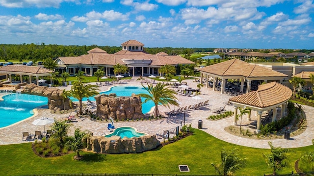 view of swimming pool with a gazebo and a lawn