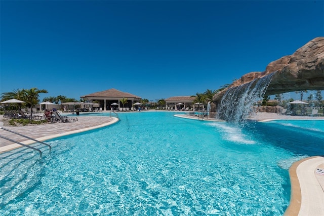 view of pool featuring pool water feature and a patio