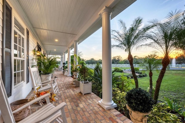 patio terrace at dusk with covered porch