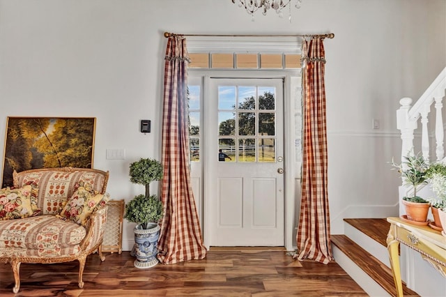 foyer entrance with a chandelier and dark hardwood / wood-style floors