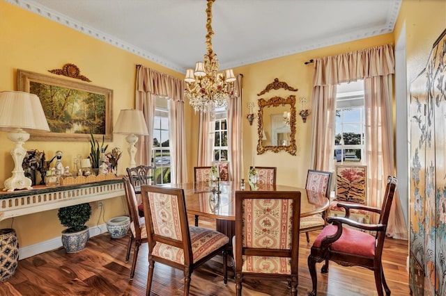 dining area featuring hardwood / wood-style floors, a notable chandelier, and crown molding