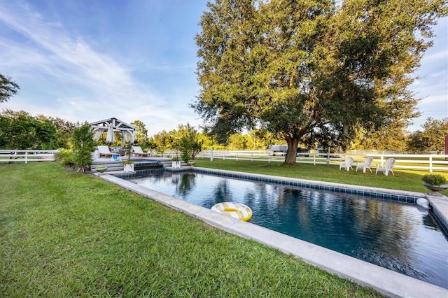 view of pool featuring a lawn