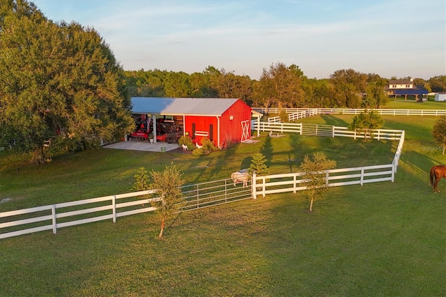 view of horse barn with a rural view