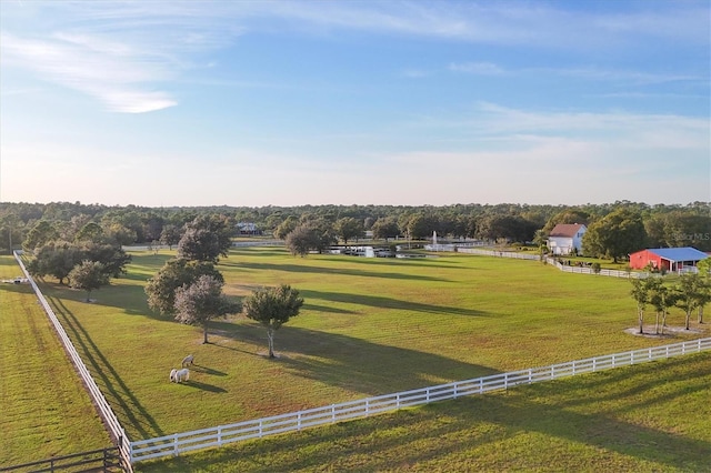 surrounding community featuring a lawn and a rural view