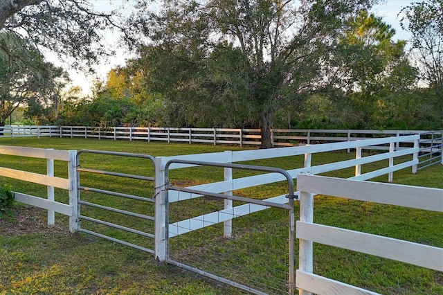 view of gate with a rural view