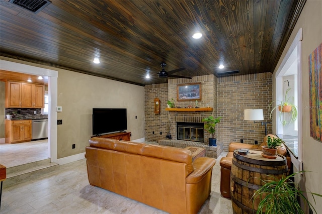 living room with wooden ceiling, a brick fireplace, light hardwood / wood-style flooring, ceiling fan, and brick wall