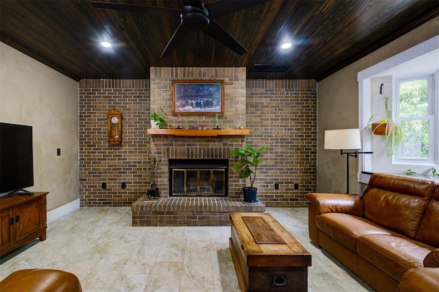 living room featuring ceiling fan, wooden ceiling, a fireplace, and brick wall