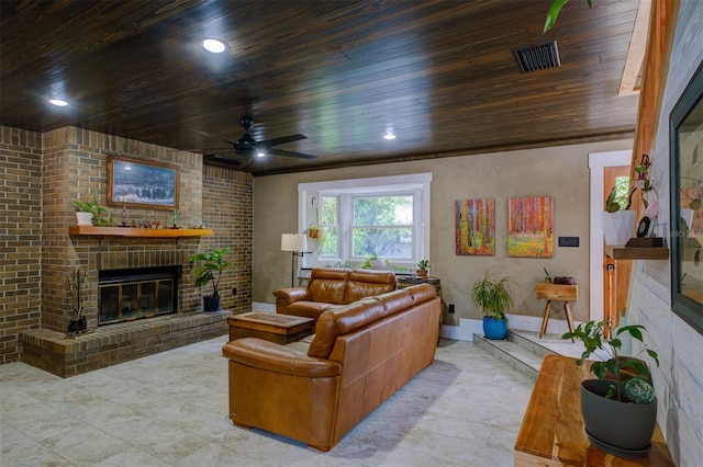 living room featuring ceiling fan, a fireplace, and wood ceiling