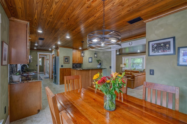 tiled dining area featuring wooden ceiling, sink, and a chandelier