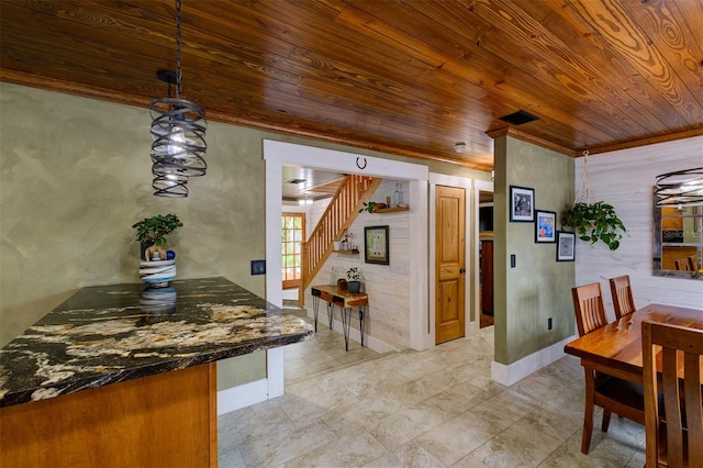 dining room featuring wood ceiling and ornamental molding