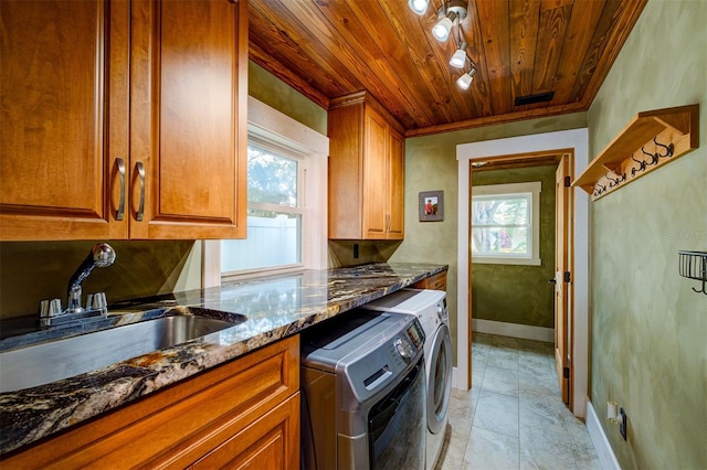 laundry area with cabinets, wood ceiling, sink, light tile patterned floors, and washing machine and dryer