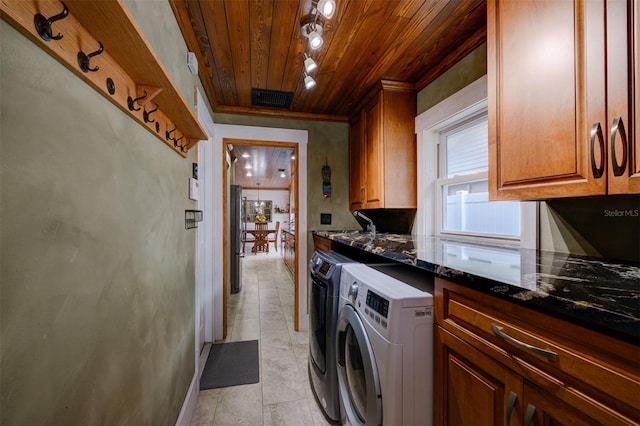 interior space featuring dark stone countertops, wood ceiling, and independent washer and dryer