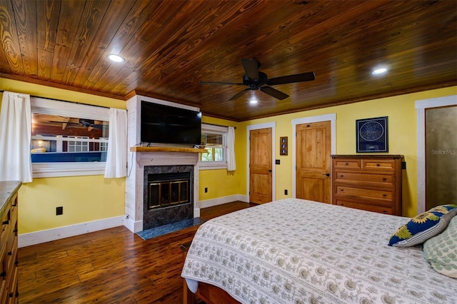 bedroom featuring a high end fireplace, dark hardwood / wood-style flooring, wood ceiling, ceiling fan, and crown molding