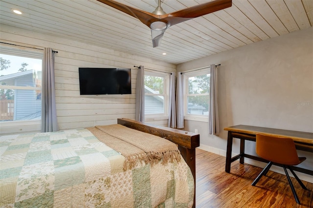 bedroom featuring multiple windows, ceiling fan, hardwood / wood-style floors, and wood ceiling