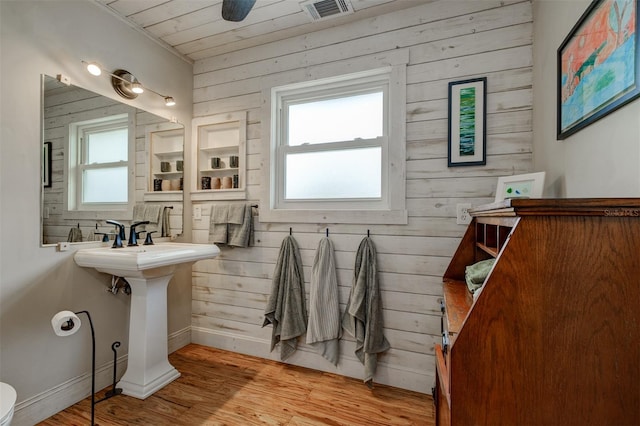 bathroom with hardwood / wood-style floors, wood ceiling, and wooden walls