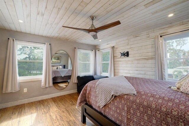 bedroom featuring multiple windows, ceiling fan, and light hardwood / wood-style floors