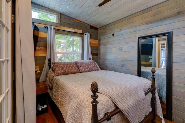 bedroom featuring wood walls, wooden ceiling, lofted ceiling, and hardwood / wood-style flooring