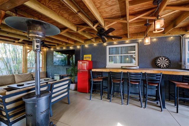 view of patio / terrace featuring ceiling fan and a bar