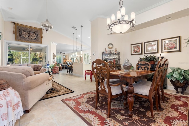 tiled dining room with ceiling fan with notable chandelier, vaulted ceiling, and crown molding