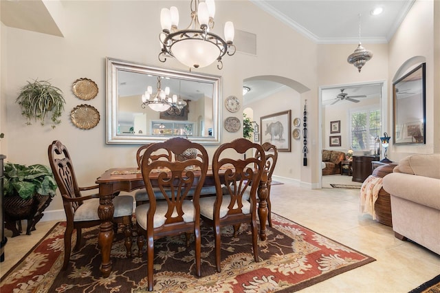 dining space with light tile patterned floors, ceiling fan with notable chandelier, and ornamental molding