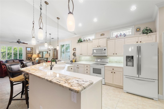 kitchen with plenty of natural light, ceiling fan, sink, and white appliances