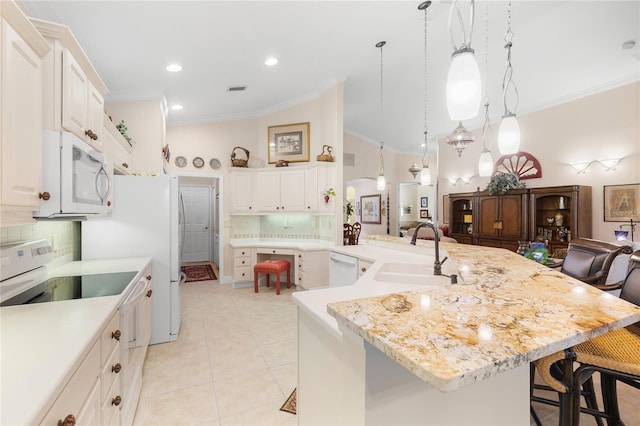 kitchen with white appliances, backsplash, a large island, and sink