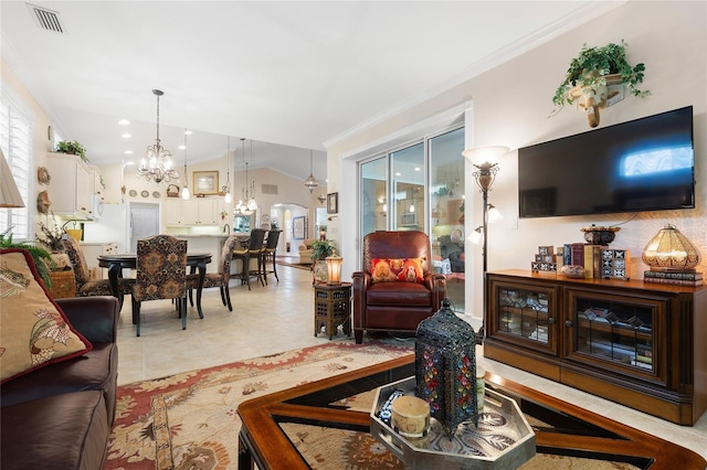 living room with a notable chandelier, light tile patterned flooring, ornamental molding, and vaulted ceiling