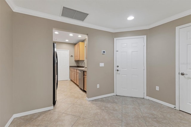 foyer with light tile patterned flooring, sink, and crown molding