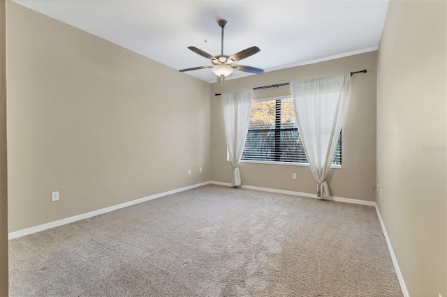 spare room featuring ceiling fan and carpet floors