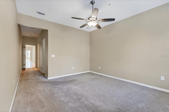 carpeted empty room featuring ceiling fan