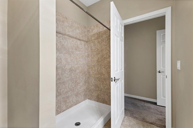 bathroom with tile patterned floors and tiled shower