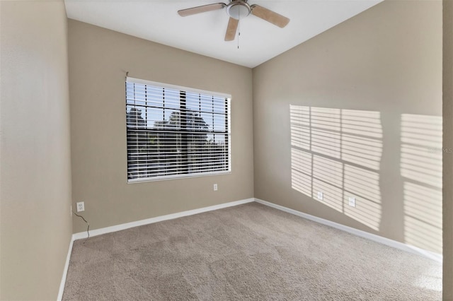 carpeted spare room featuring ceiling fan