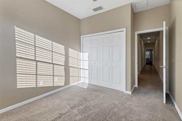 unfurnished bedroom with carpet flooring and a closet