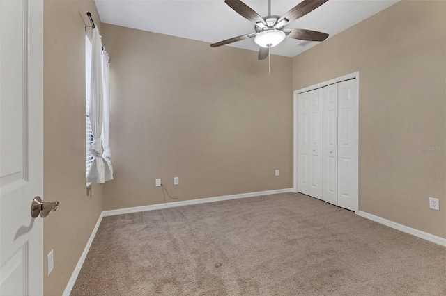 unfurnished bedroom with carpet floors, a closet, and ceiling fan