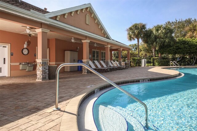 view of pool with ceiling fan, exterior kitchen, and a patio