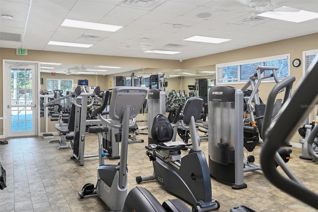 gym with a paneled ceiling