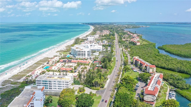 bird's eye view featuring a water view and a beach view