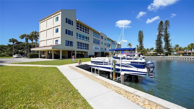 view of dock featuring a yard and a water view