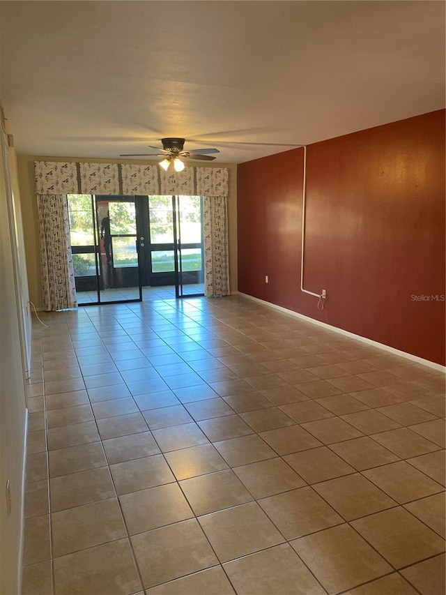 unfurnished room featuring ceiling fan and light tile patterned flooring