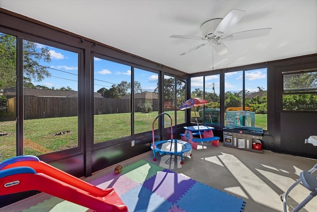 sunroom / solarium featuring ceiling fan and a wealth of natural light