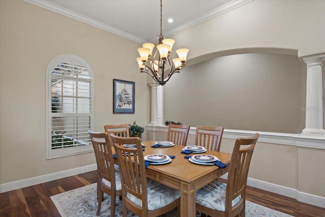 dining space with ornate columns, an inviting chandelier, dark wood-type flooring, and crown molding