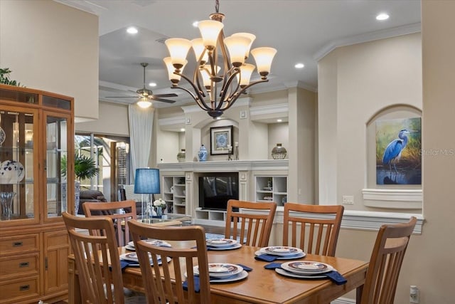 dining room with a fireplace, ceiling fan with notable chandelier, and ornamental molding