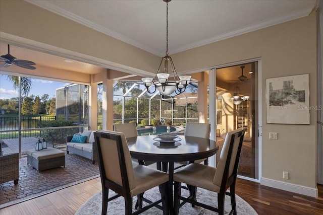 dining space featuring hardwood / wood-style floors, ceiling fan with notable chandelier, and crown molding