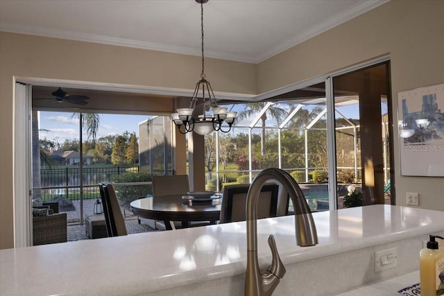 dining room featuring ceiling fan with notable chandelier and crown molding