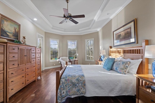 bedroom with a raised ceiling, ceiling fan, dark wood-type flooring, and ornamental molding